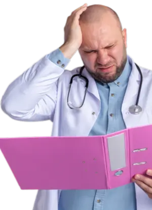 Frustrated doctor looking at paperwork, showing challenges of claim denials addressed by Human Medical Billing