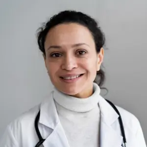 Dr. Lisa Raymond smiling in white coat, representing professional care with Human Medical Billing