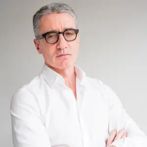 Dr. Michael Anderson in white shirt and glasses, symbolizing expert healthcare guidance