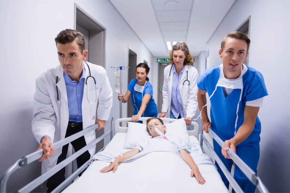 Medical staff rushing patient on stretcher in emergency corridor