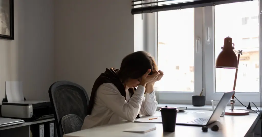 Physician experiencing burnout from after-hours EHR charting, highlighting the need for efficient medical billing and workflow support.