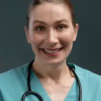 Cheerful nurse in teal scrubs with stethoscope, symbolizing Human Medical’s engaged healthcare audience.