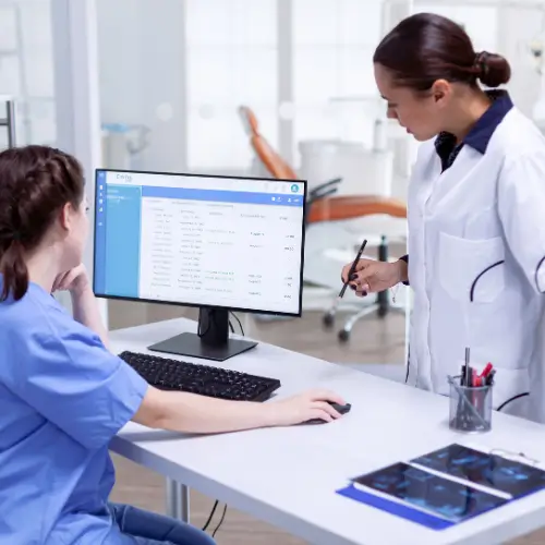 Healthcare staff reviewing appointment and claims data, representing revenue cycle management solutions.