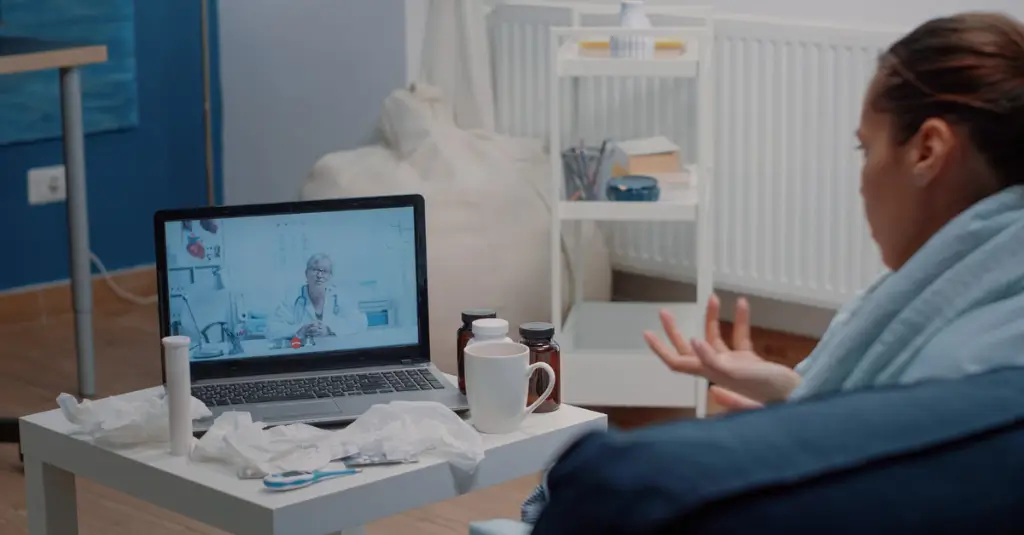 Patient participating in a remote patient monitoring virtual visit with a physician using telehealth technology.